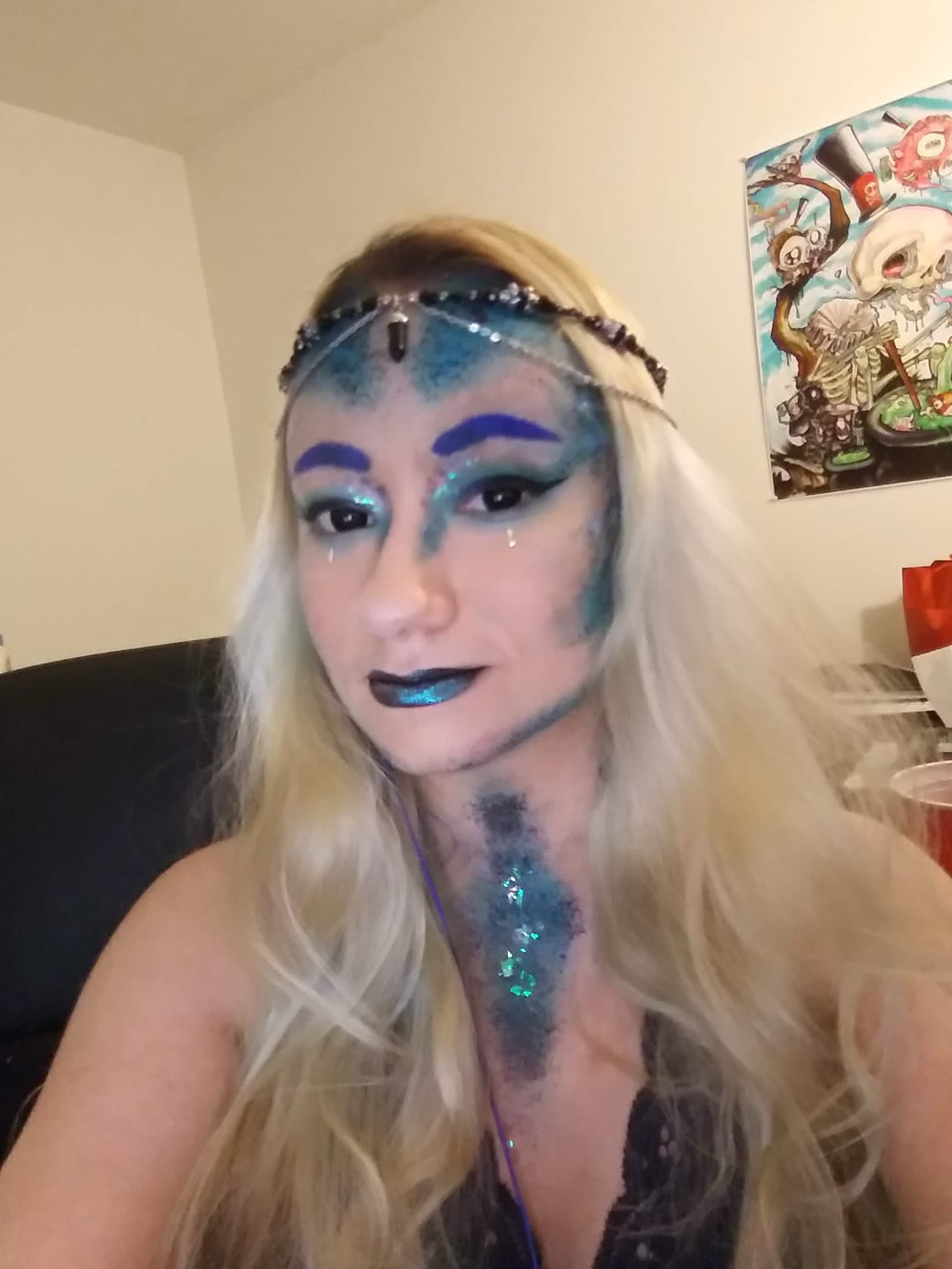Tidewitch — Teal glitter scales, cobalt brows and a chained headpiece.