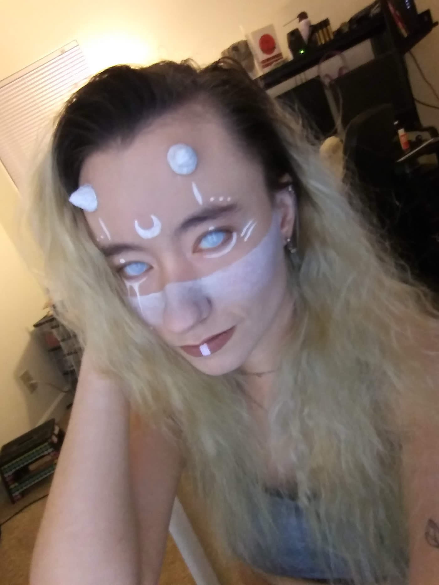 Moonspeaker — White ritual markings — crescents, dots and a pale masked jaw.